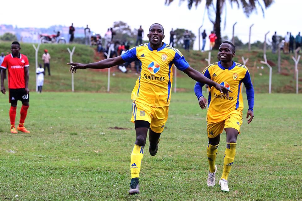 Geoffrey Sserunkuuma (front) celebrates after scoring the lone strike against Vipers in the 2016 FUFA Super Cup at Wankulukuku, behind him is Paul Mucureezi