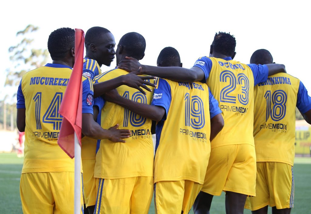 KCCA FC players join Muzamir Mutyaba in celebrating their second of the game against BUL FC at Lugogo on Tuesday